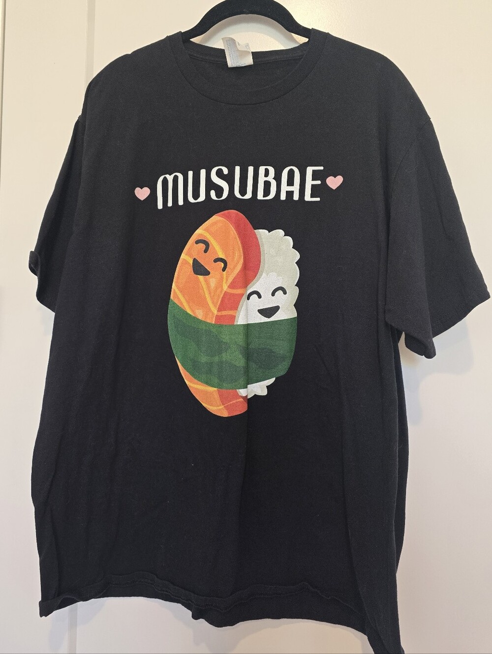 Musubae Shushi Black T-Shirt Featuring Smiling Sushi Graphic